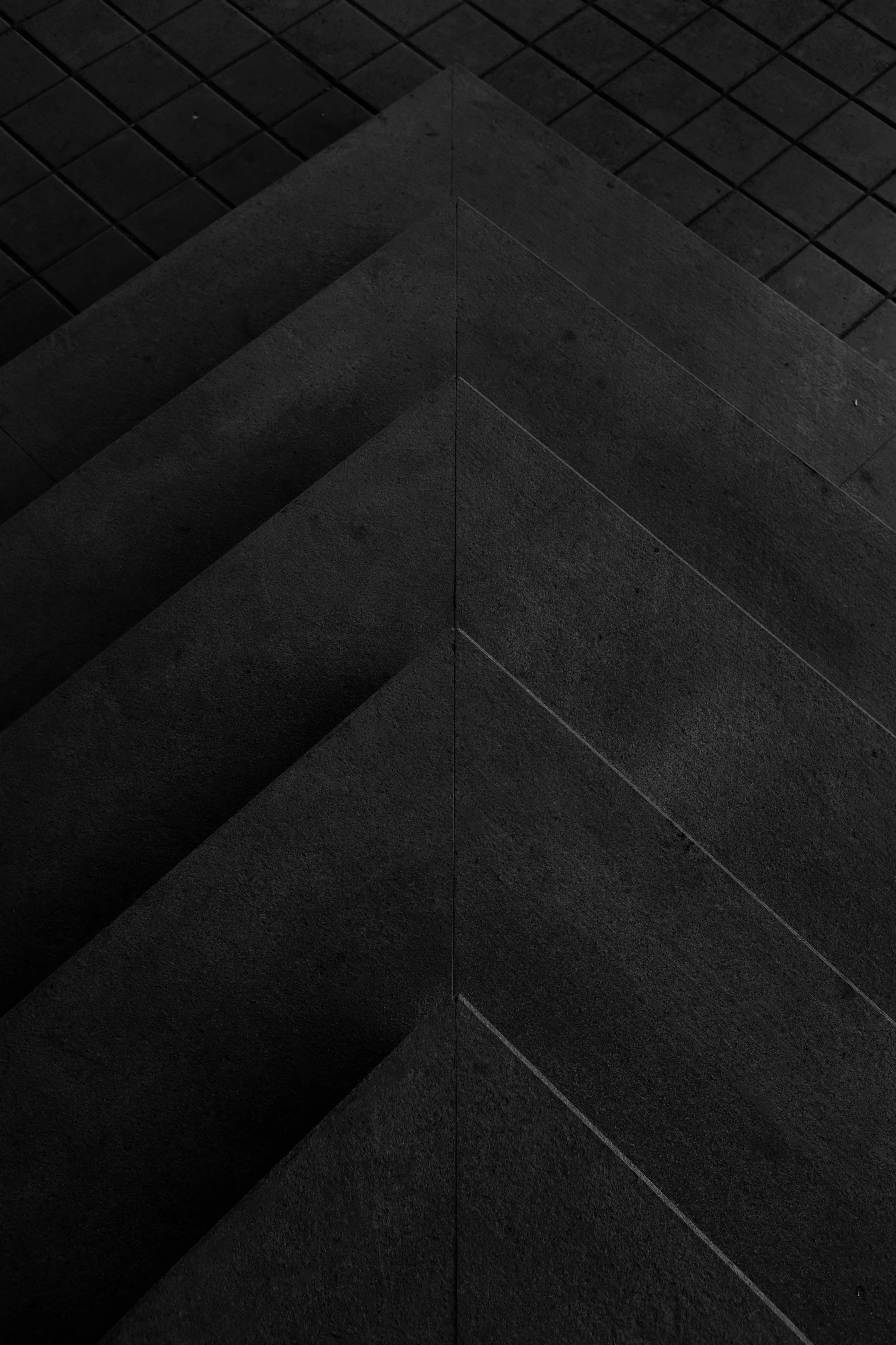 Dark architectural stone with sharp diagonal planes